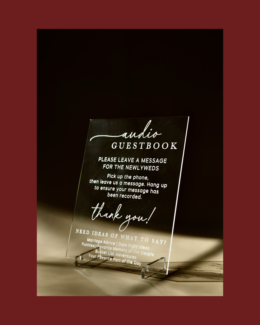 Clear acrylic audio guestbook with text on a dark background